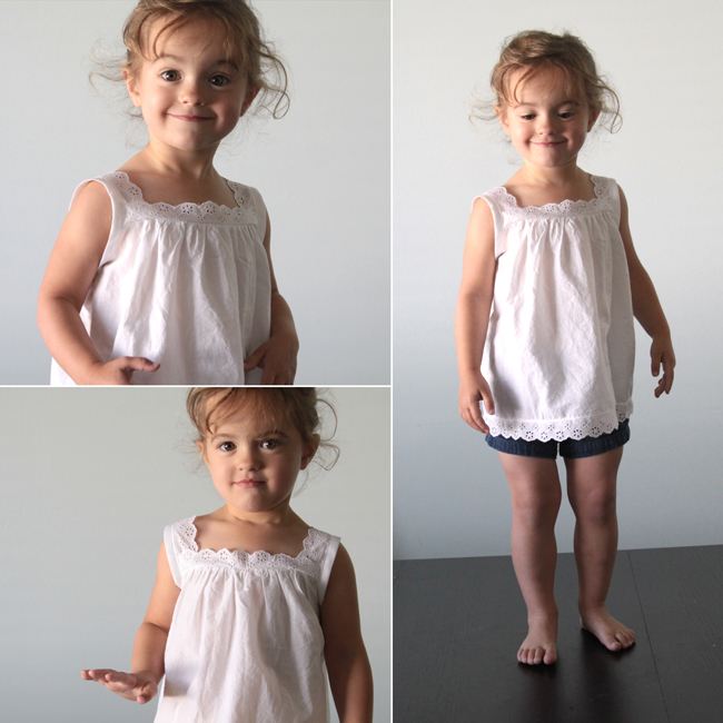 A little girl wearing a lace trim white blouse