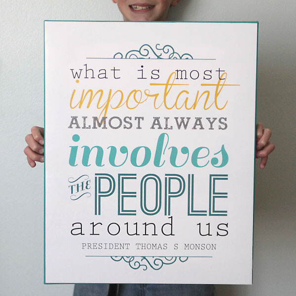 boy holding a printable sign that says What is most important almost always involved the people around us President Thomas S Monson