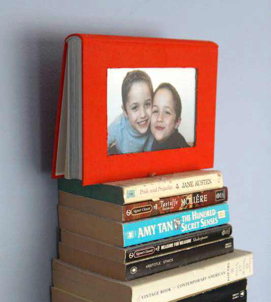 DIY photo frame made from a book with rectangle cut out of the front cover