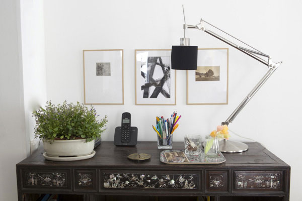 Modern looking photo frames on a wall above a desk