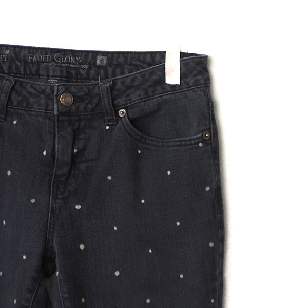 A closeup of jeans with white polka dots