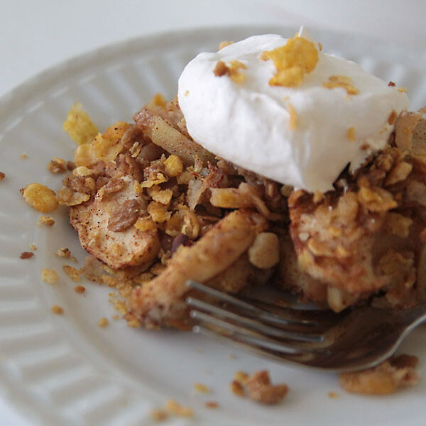 healthy apple crisp on a plate with whipped topping