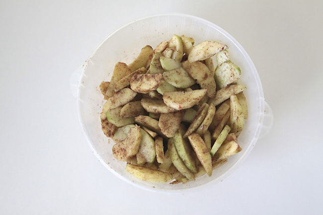 apples tossed with cinnamon and sugar in a bowl