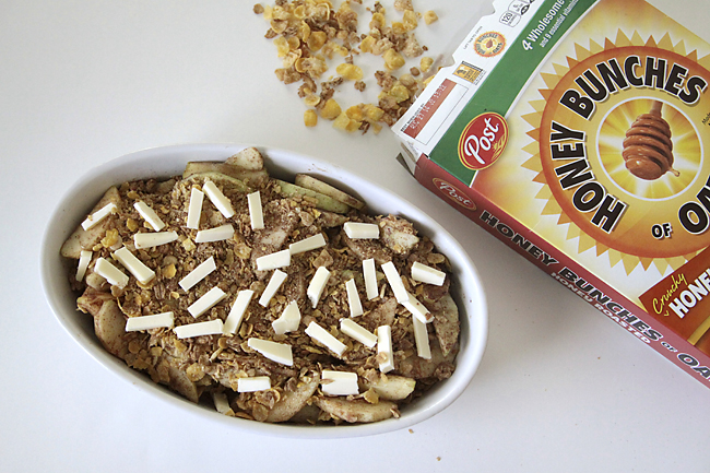 apples covered with cereal and slice butter, with box of Honey Bunches of Oats