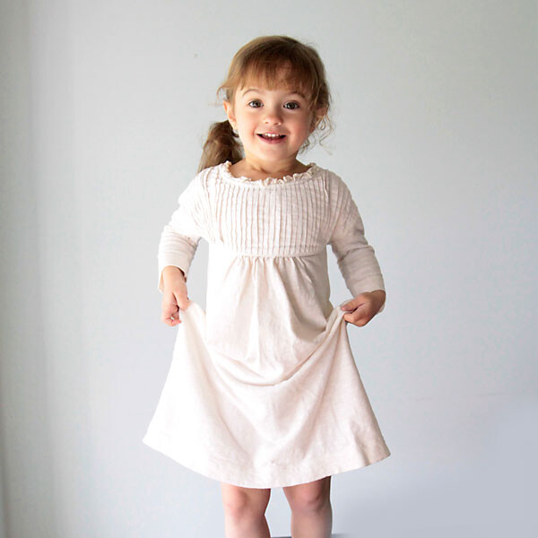 A little girl in a white nightgown made from a t-shirt