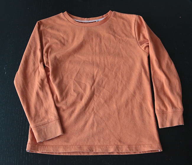 An orange pajama top with long sleeves