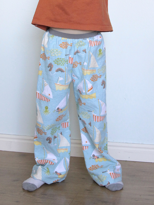 A boy wearing flannel pajama pants