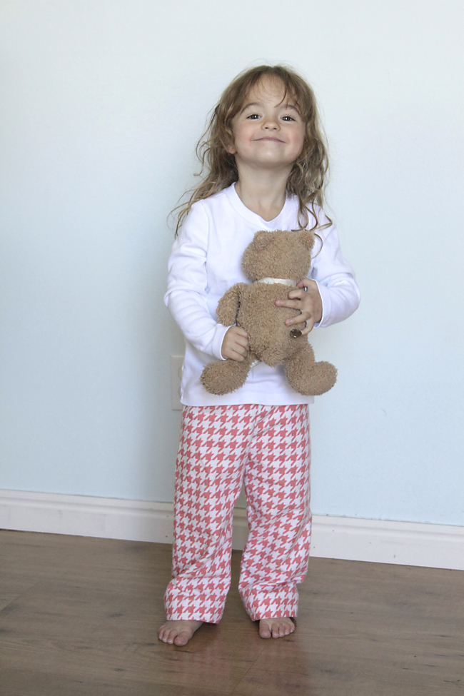 A little girl holding homemade pajamas