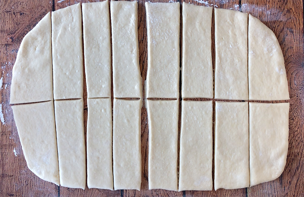 Bread dough rolled out in a rectangle and cut into sticks