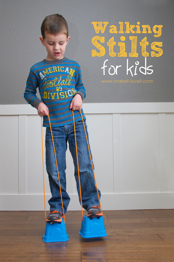 A little boy that is standing on DIY stilts