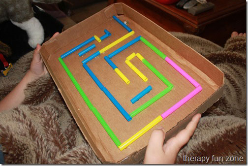 Fun kid activity maze made from a cardboard box lid and straws