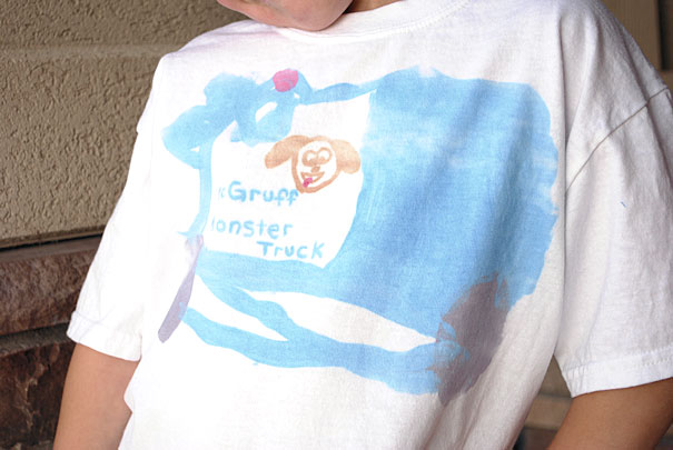 A young boy in t-shirt with his drawing on it