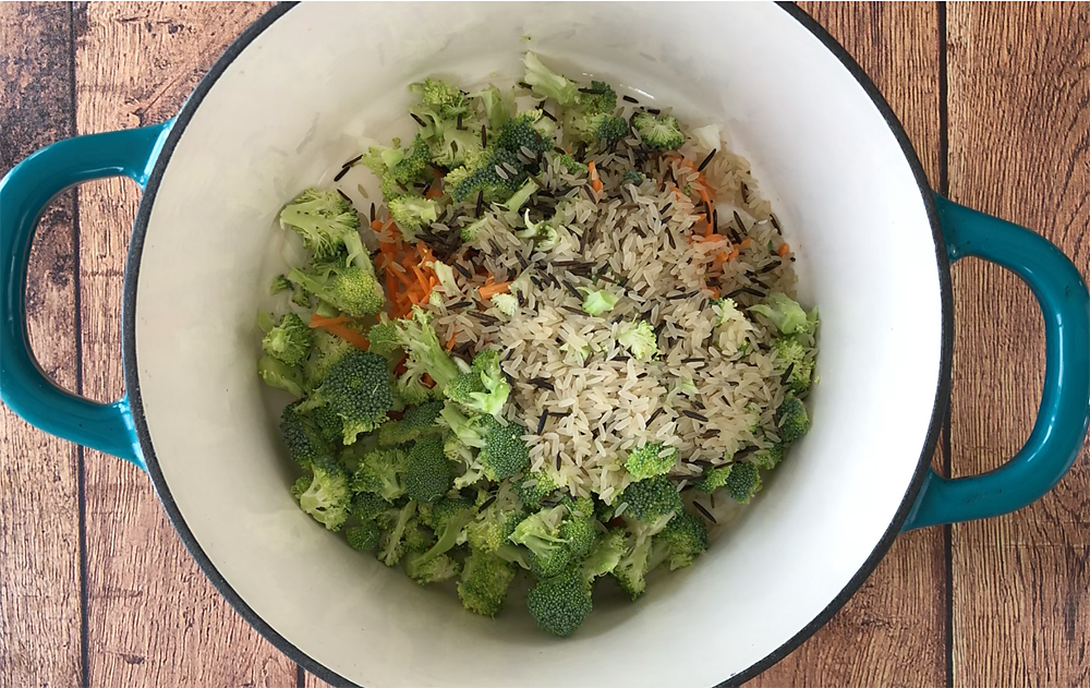 Chicken and rice soup ingredients in a pot