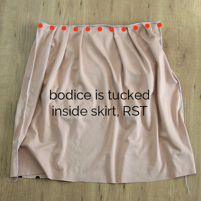 Skirt is pleated to be the same width as the bodice; bodice is tucked inside skirt right sides together