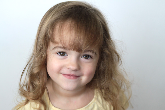 A little girl smiling at the camera