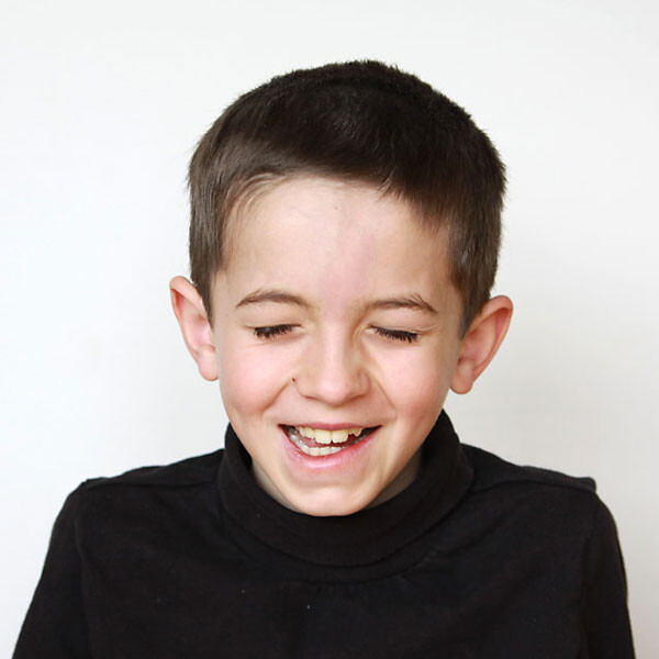 A young boy who is laughing