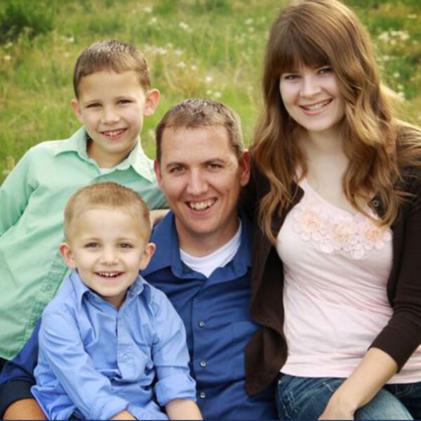 A family posing for a photo in the grass