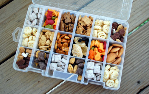 A divided snack container box filled with different types of food for a road trip