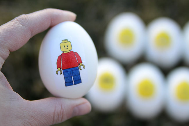 Hand holding an Easter egg with a lego minifig on it