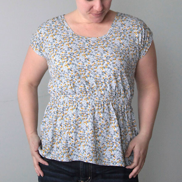 A woman wearing a floral t-shirt with gathered waistline