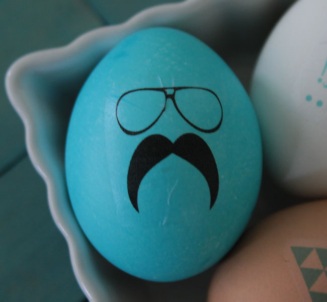 Blue Easter egg with glasses and mustache design