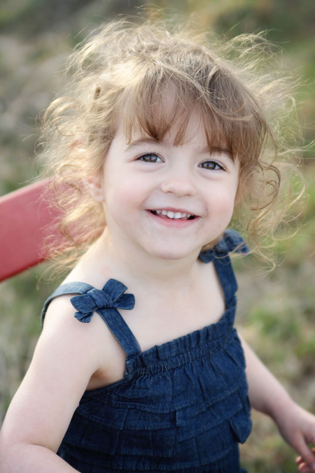 A little girl smiling at the camera