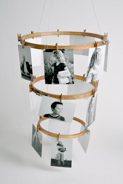 Wood hoops with photos attached with clothespins