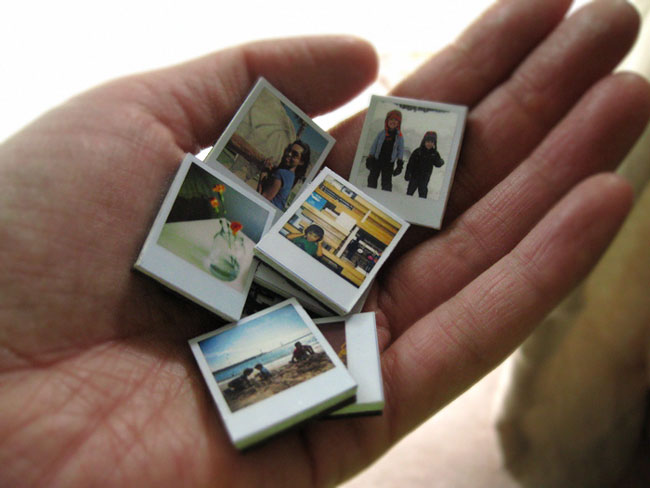 Hand holding little photo tiles