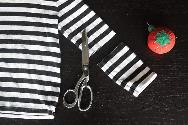 Striped shirt with the long sleeve cut off; scissors and pin cushion