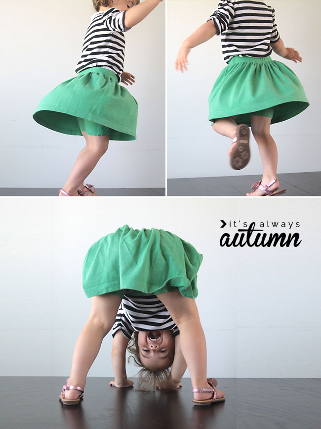 A little girl spinning and playing wearing a skirt with attached shorts