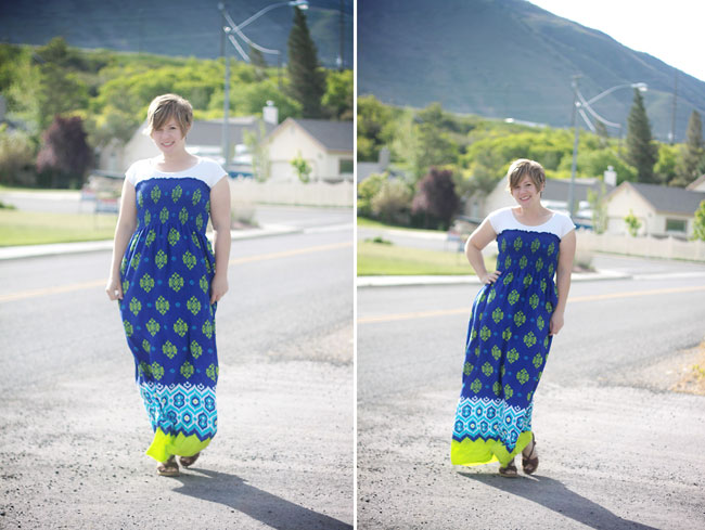 A person woman standing in a parking lot wearing a blue maxi dress