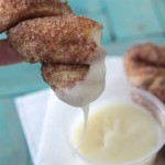 Cinnamon sugar breadstick being dipped in frosting