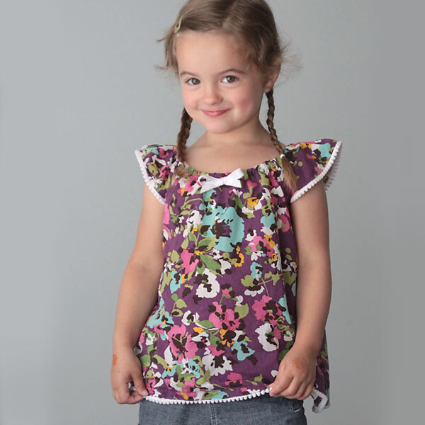 A young girl in a flutter sleeve top made from a free sewing pattern