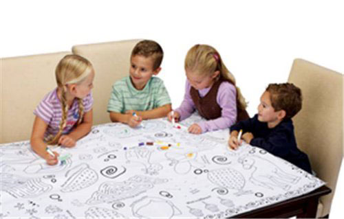 Kids sitting around a giant coloring table cloth