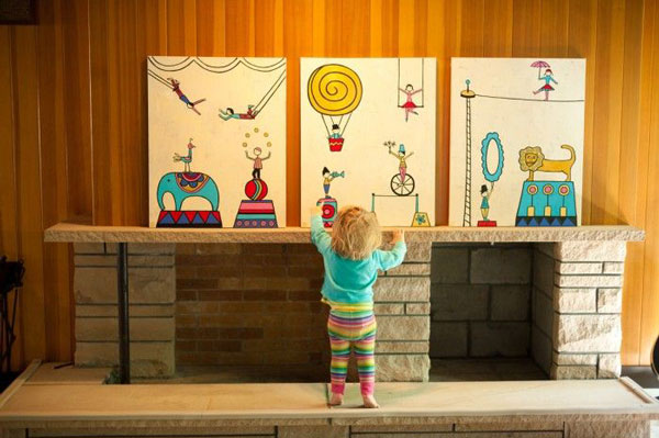 little girl standing in front of large circus panels to color