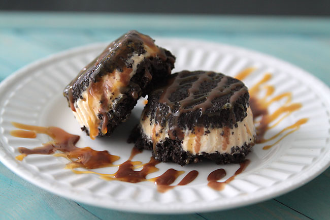 Two Oreo ice cream sandwiches with fudge and caramel topping cold dessert