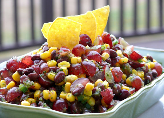 A bowl with bean and grape salsa
