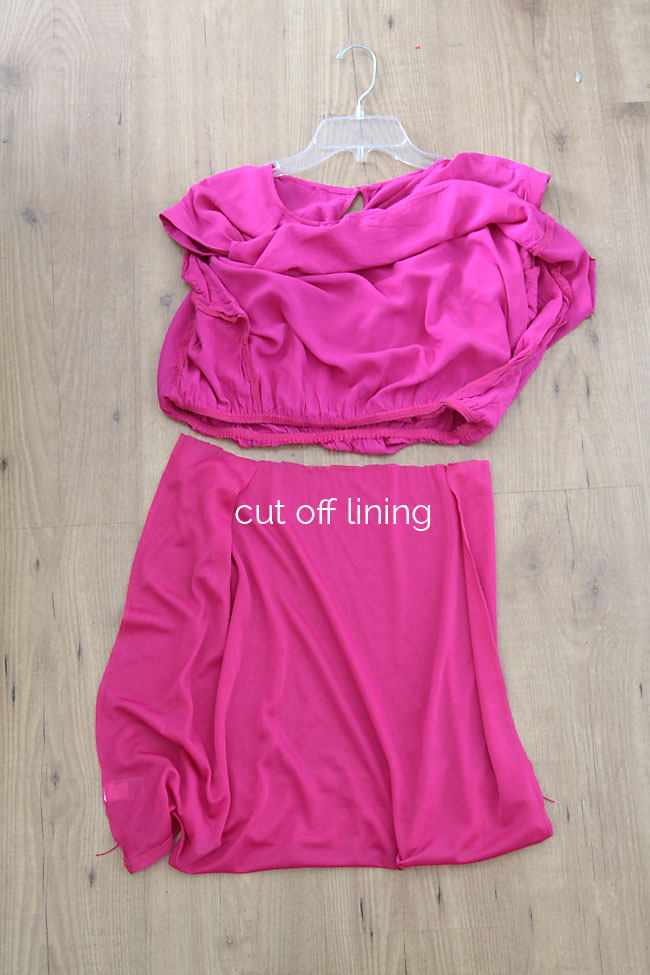 Cutting off the lining of a pink dress