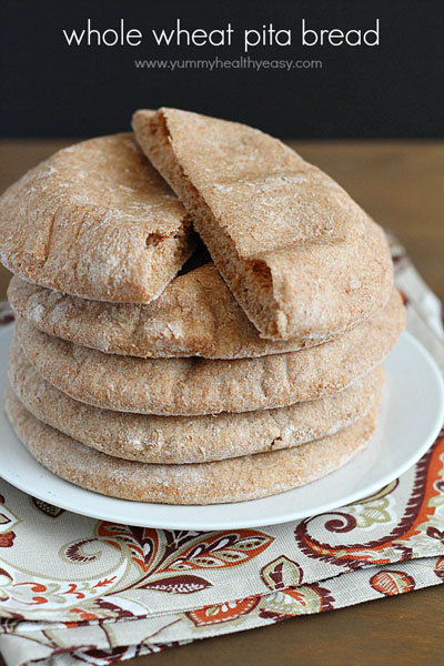 whole wheat pita bread stacked on a plate