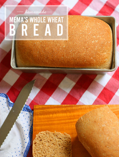 loaf of whole wheat bread in a tin, another loaf on a cutting board