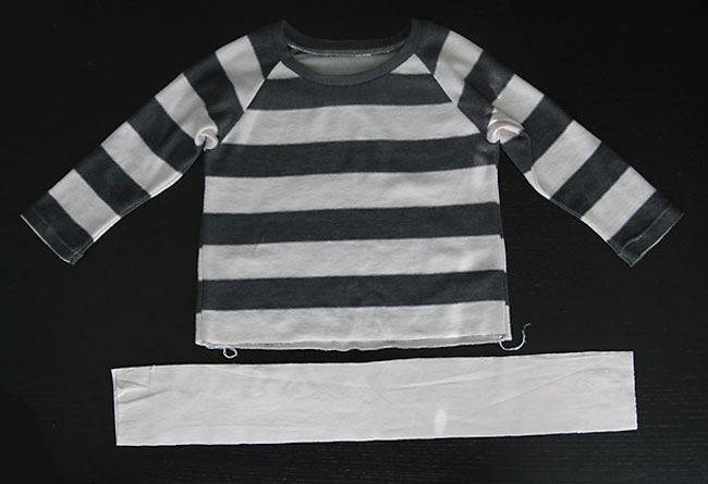 A girls sweater with long strip of fabric