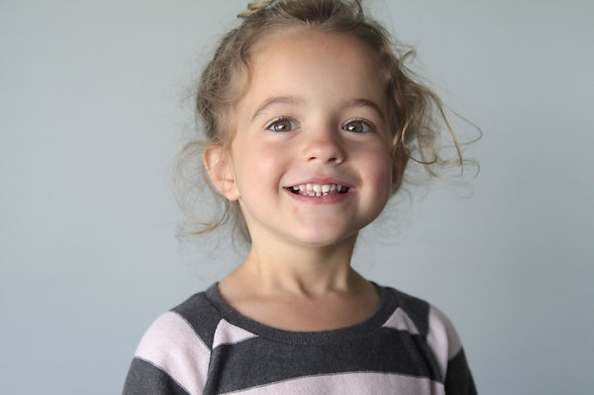 A young girl smiling at the camera