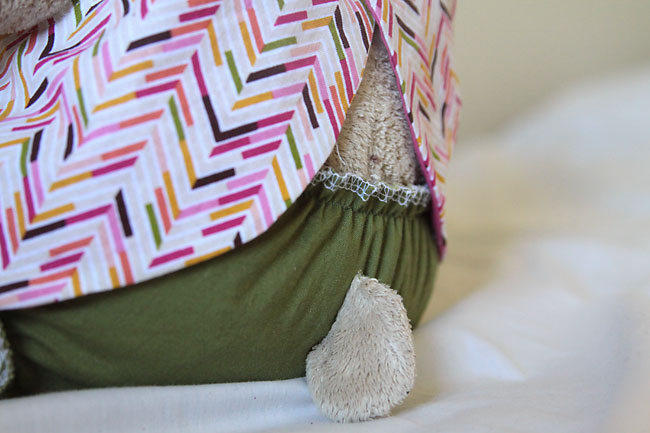 Teddy bear tail peeking out through hole in the bloomers