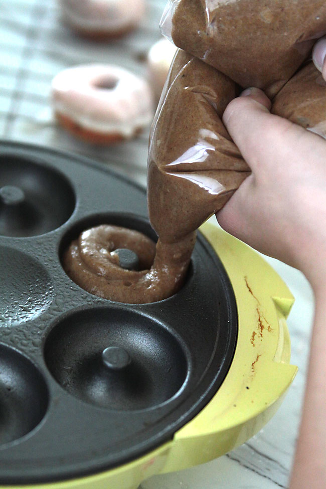 Hand piping batter into donut maker