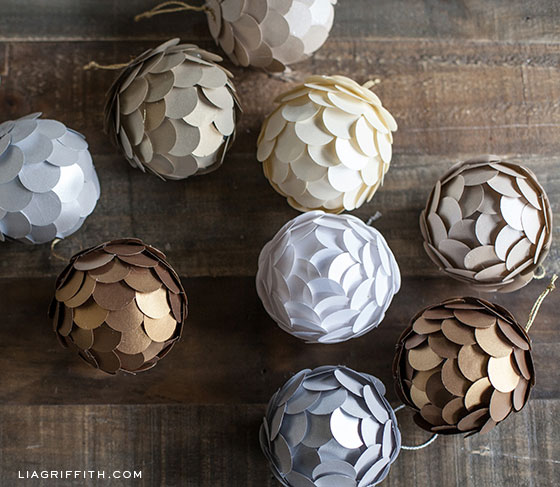 Christmas ornament balls covered in circles of metallic paper