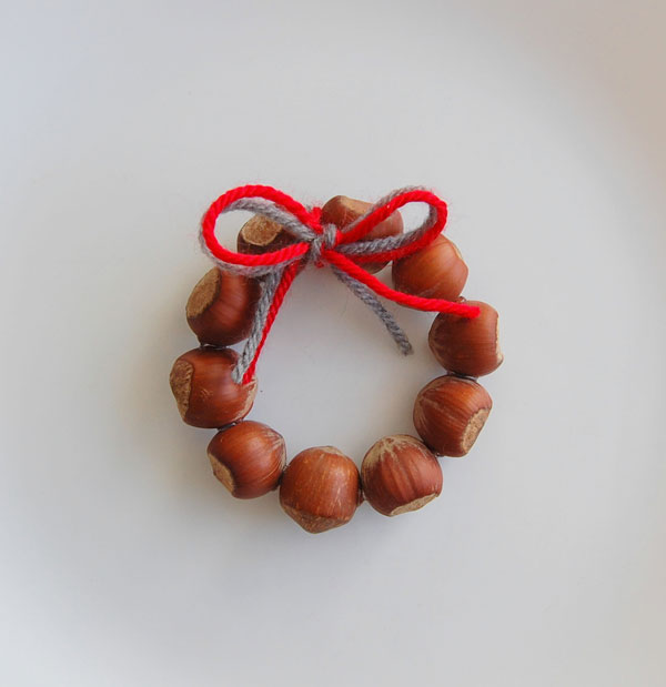 DIY Christmas ornament made from ring of acorns that looks like a wreath