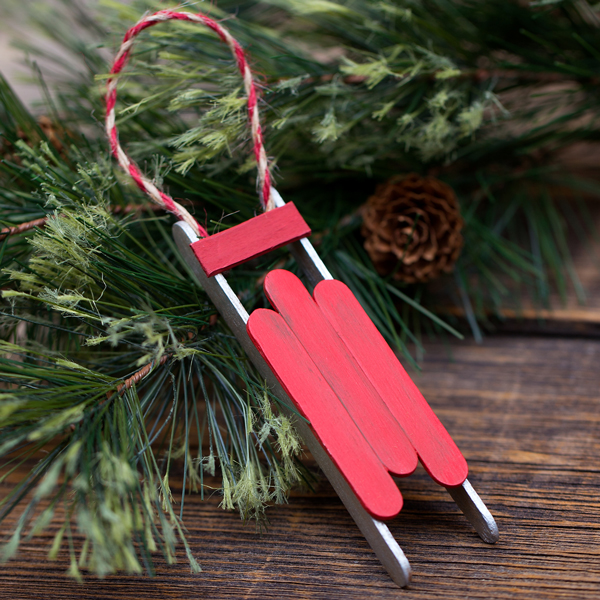 A sled Christmas ornament made from popsicle sticks