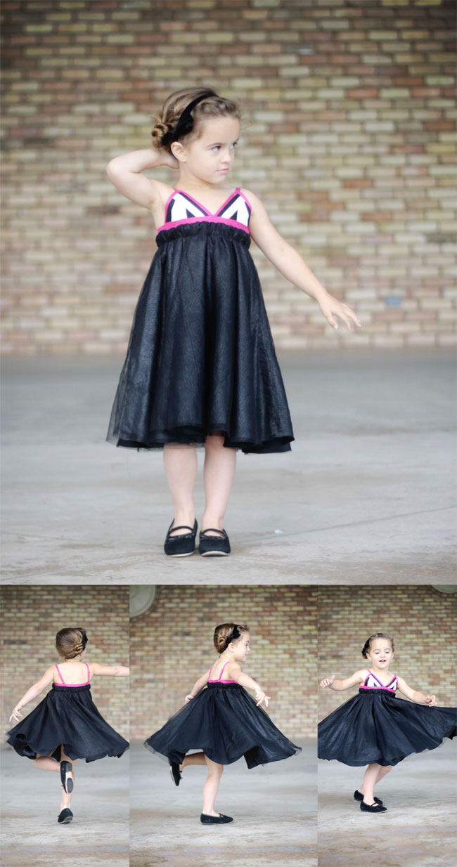 A little girl twirling in a dress with a full black skirt