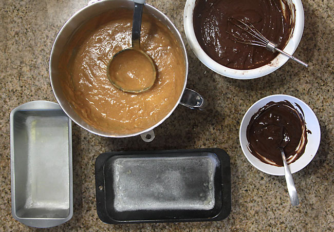 pumpkin bread batter, chocolate bread batter, melted chocolate, greased and floured bread tins