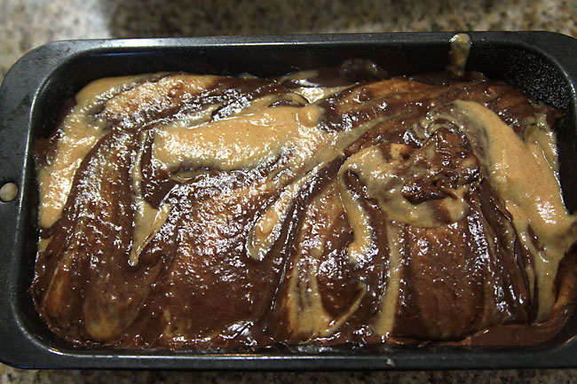 pumpkin and chocolate batters swirled in a bread pan